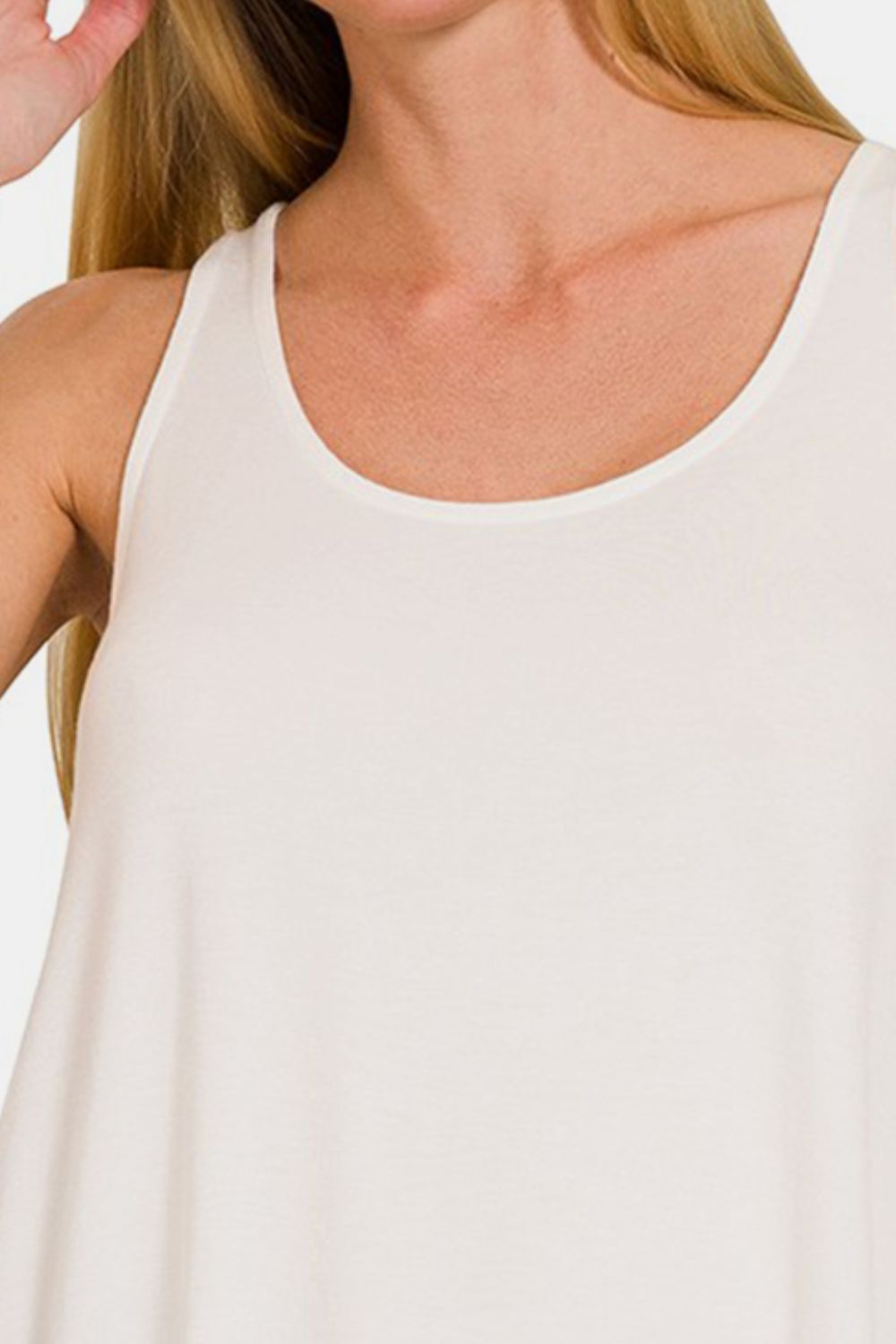 The Round Neck Flowy Hem Tank is a stylish and versatile clothing piece that features a flattering flowy hem design. It is perfect for casual outings or even dressed up with accessories for a more sophisticated look. The round neck adds a classic touch to the tank top, making it easy to pair with different bottoms. S-XL