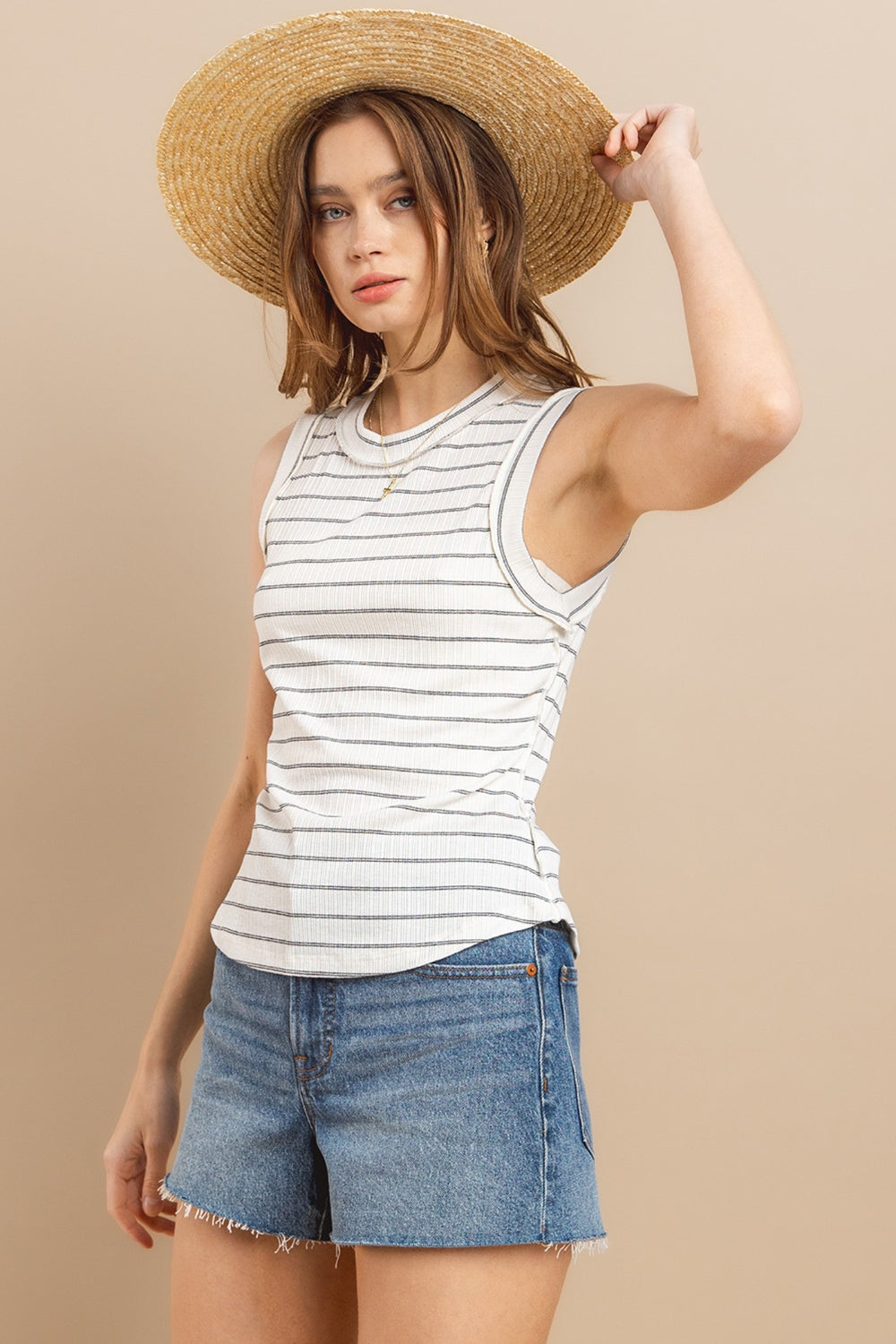 Stay cool and stylish this summer with our Striped Round Neck Tank. Made from soft and breathable fabric, this tank features a classic round neck design and trendy striped pattern. Perfect for pairing with your favorite jeans or shorts for a casual and chic look. Available in a variety of colors to suit your style preferences. S-L