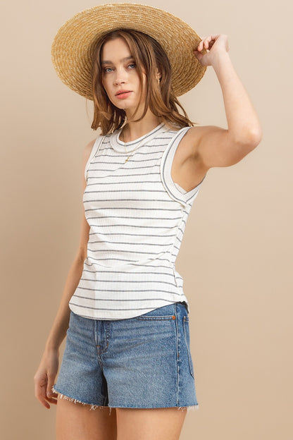 Stay cool and stylish this summer with our Striped Round Neck Tank. Made from soft and breathable fabric, this tank features a classic round neck design and trendy striped pattern. Perfect for pairing with your favorite jeans or shorts for a casual and chic look. Available in a variety of colors to suit your style preferences.  S-L