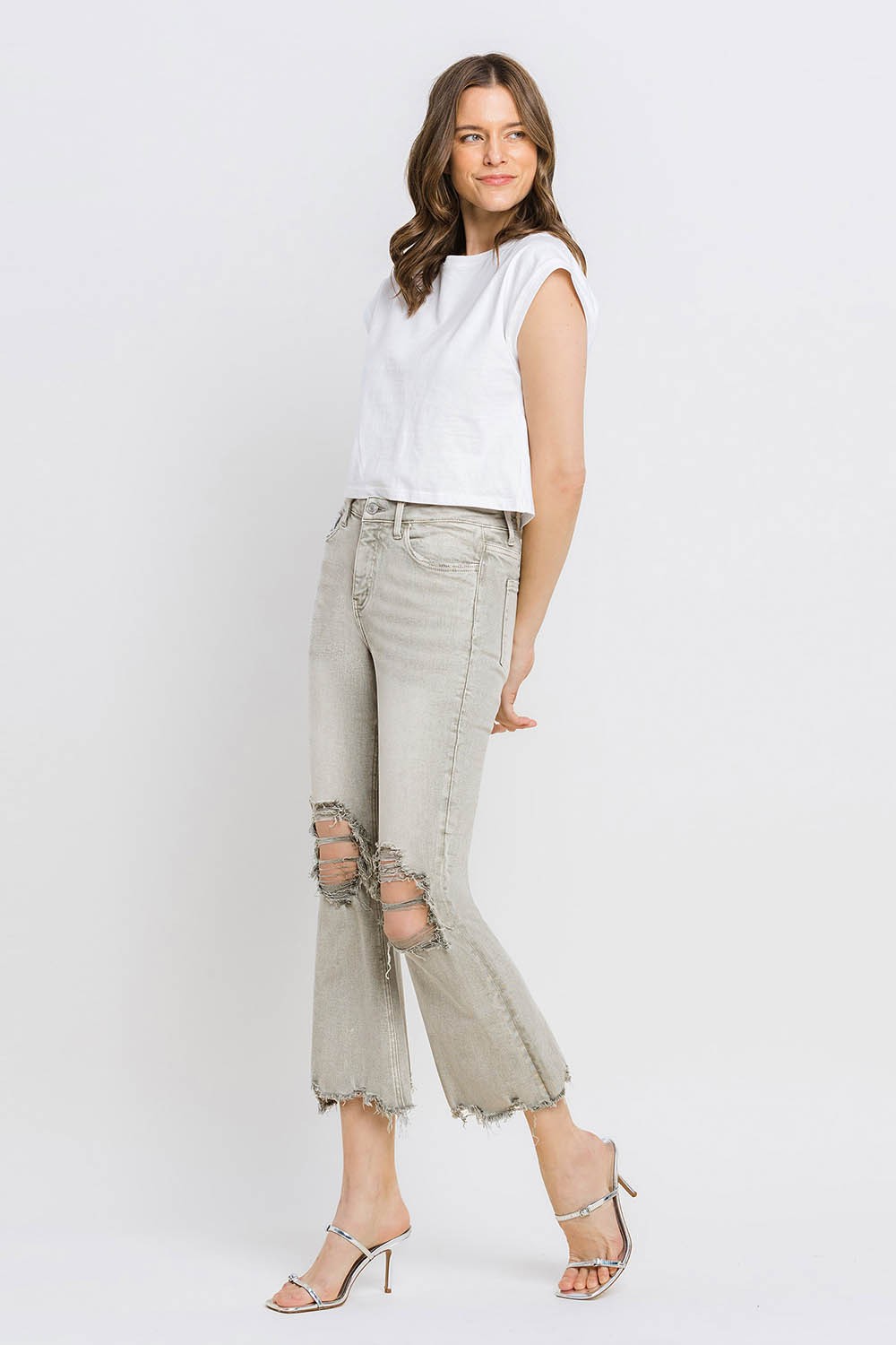 These distressed raw hem cropped flare jeans offer a perfect blend of edgy and retro style. The distressed detailing adds a touch of urban flair to the flared silhouette. The raw hem finishes off the look with a trendy, unfinished edge. Pair these jeans with a tucked-in graphic tee and platform sandals for a vintage-inspired outfit.  24-32