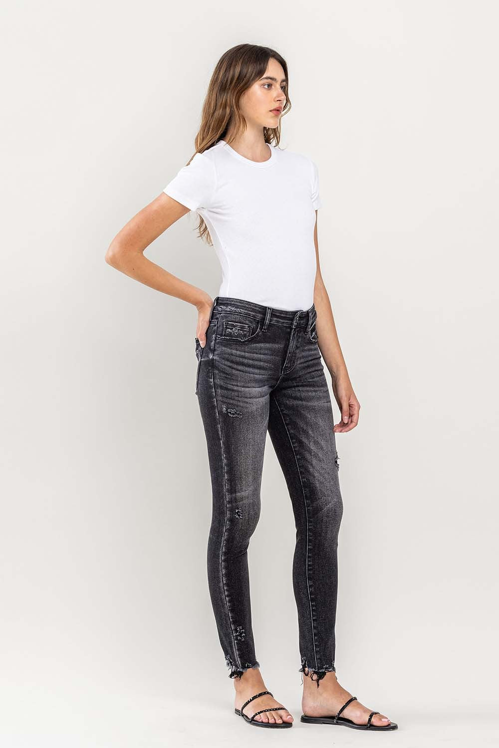 These raw hem cropped skinny jeans are a must-have for any fashion-forward individual. The raw hem adds a touch of edge to the classic skinny jeans silhouette. The cropped length is perfect for showcasing your favorite footwear. 24-32