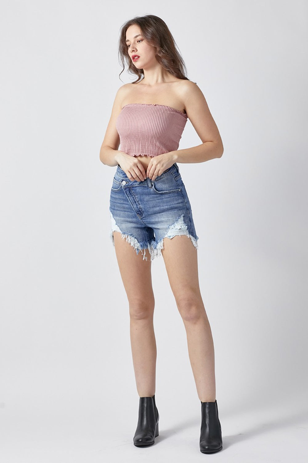 Raw Hem Asymmetrical Waist Denim Shorts are a fashion-forward and edgy choice for those looking to make a statement with their summer wardrobe. The raw hem adds a touch of casual cool, while the asymmetrical waist detail sets these shorts apart from the ordinary. Made from sturdy denim, they offer both style and comfort for all-day wear. S-XL