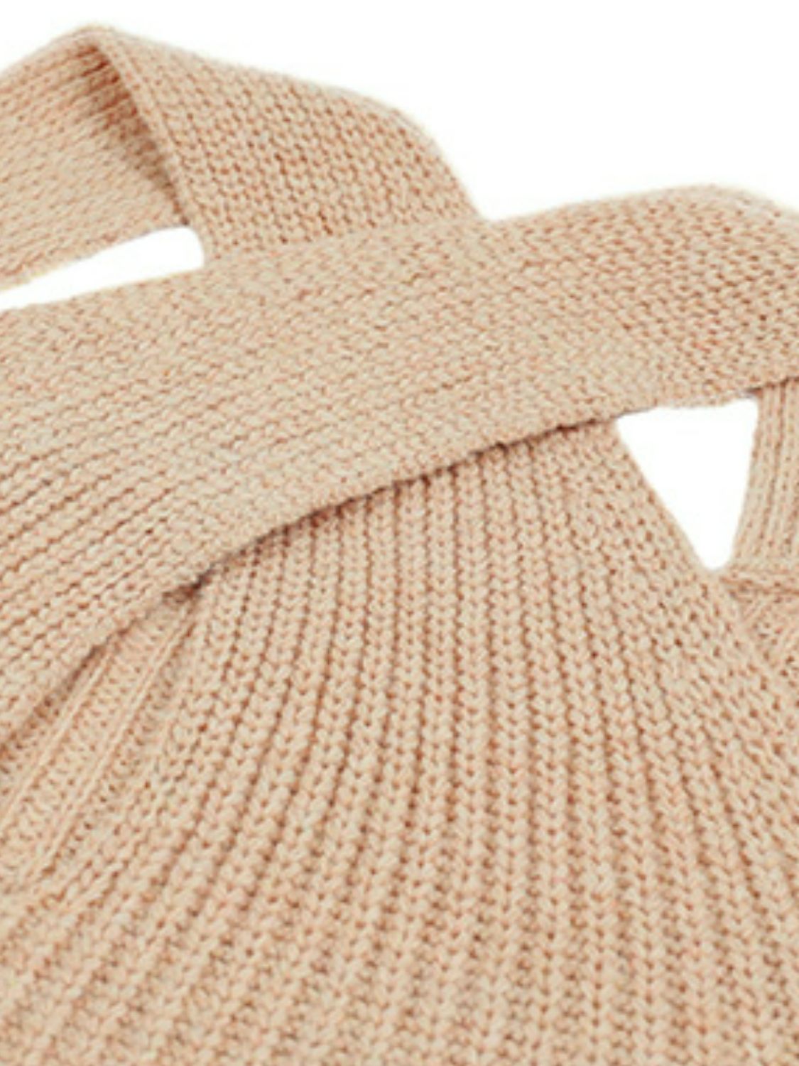 “Bonfire Nights” is a long sleeve rib-knit sweater featuring a crisscross design, cold shoulder, grecian neckline, ribbed cuffed sleeves and hemline. The color is khaki. Sizes small through x-large.