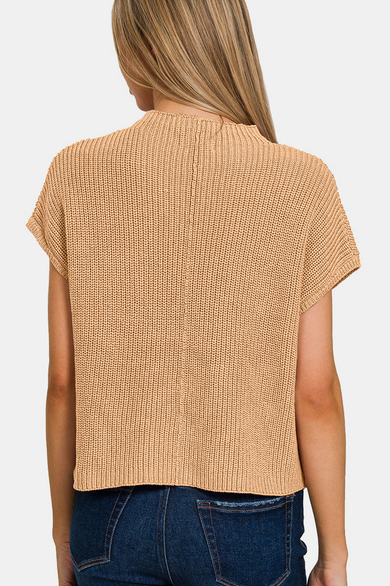 The Mock Neck Short Sleeve Cropped Sweater is a trendy and versatile piece for your wardrobe. With its mock neck design, this sweater adds a modern and chic touch to any outfit. The short sleeves make it perfect for transitioning between seasons or for layering with other pieces. S-L
