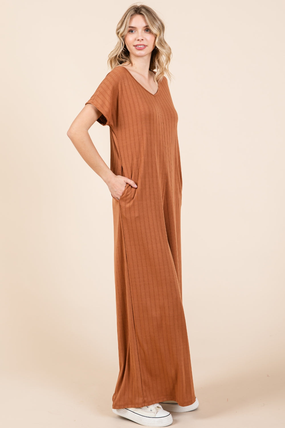 The Ribbed Short Sleeve Wide Leg Jumpsuit is a trendy and versatile fashion piece that offers both style and comfort. With a ribbed texture and wide-leg silhouette, this jumpsuit combines a chic look with a relaxed fit. The short sleeves add a casual touch, making it suitable for various occasions. S-XL