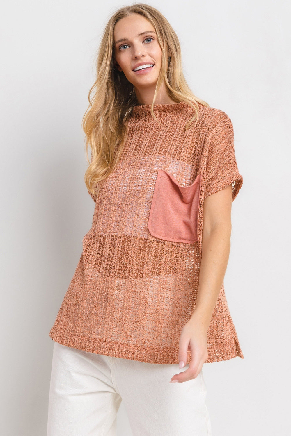 The See Through Crochet Mock Neck Cover Up is a stylish and versatile addition to your wardrobe. Perfect for layering over a swimsuit or pairing with a camisole for a boho-chic look. The intricate crochet detailing adds a touch of texture and visual interest. S-L