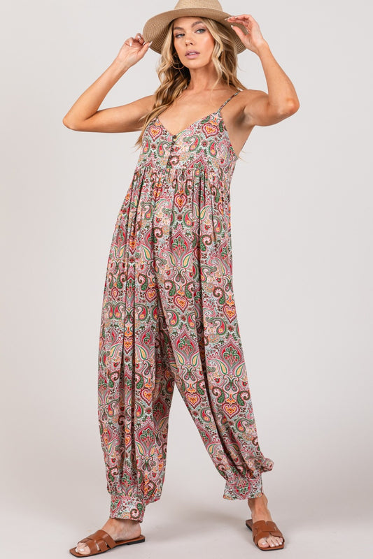 The Multi Paisley Print Sleeveless Jumpsuit is a chic and versatile piece that exudes bohemian charm. The colorful paisley print adds a pop of vibrancy and energy to the jumpsuit, making it a statement piece for any occasion. The sleeveless design and flowy silhouette offer a comfortable and flattering fit, perfect for warm weather or casual outings.  S-X