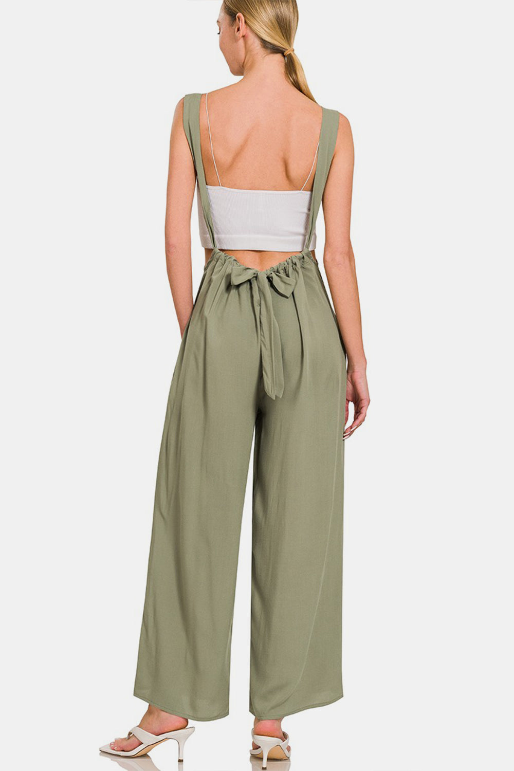 Pocketed Wide Strap Wide Leg Overalls are a trendy and functional fashion choice. Featuring wide straps for added comfort and style, these overalls are designed with a wide-leg silhouette for a chic and relaxed look. The addition of pockets adds practicality to this versatile piece, allowing you to carry small essentials while on the go. Whether paired with a casual tee or dressed up with a blouse, these overalls are a fashion-forward option for any casual outing. S-L
