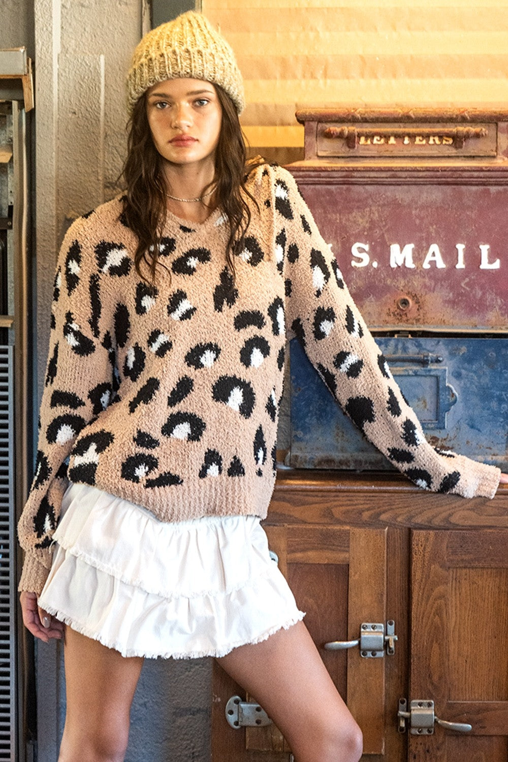 This is a long sleeve, v-neck, hooded popcorn sweater with animal print. Sizes small through large.