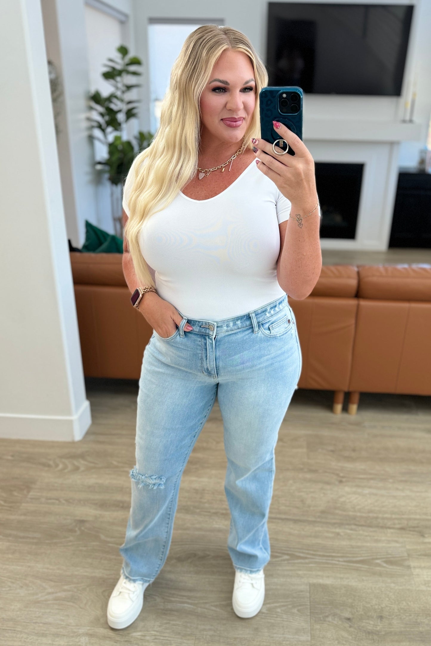 Rock the hottest trend with the Parker High Rise 90's Straight Jeans! Featuring a light wash and distressed front and back, these jeans offer a unique and stylish look. Their high rise and 90's straight silhouette provide a flattering fit for any body type. Upgrade your wardrobe with these must-have jeans! 0-24W