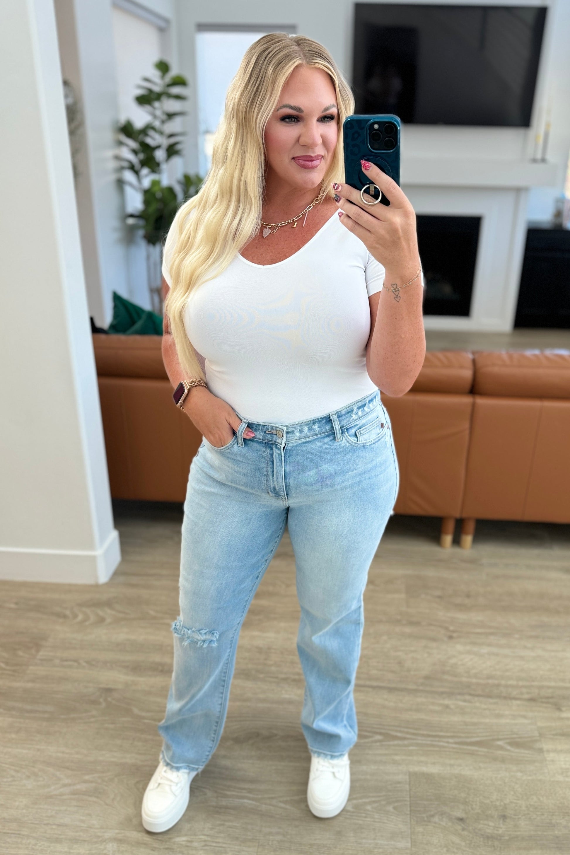 Rock the hottest trend with the Parker High Rise 90's Straight Jeans! Featuring a light wash and distressed front and back, these jeans offer a unique and stylish look. Their high rise and 90's straight silhouette provide a flattering fit for any body type. Upgrade your wardrobe with these must-have jeans! 0-24W
