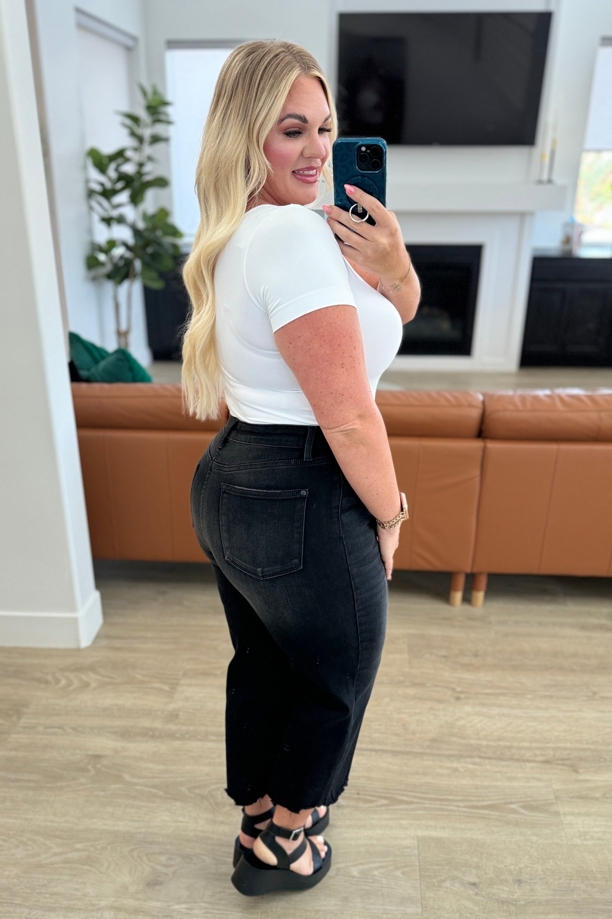 Get ready to rock stylishly with Ryan High Rise Jeans! These wide leg crop jeans feature a coordinating button fly and a washed out black garment dye for a cool, edgy look. With a high rise and raw hem, you'll stand out in the best way possible.  0-24W