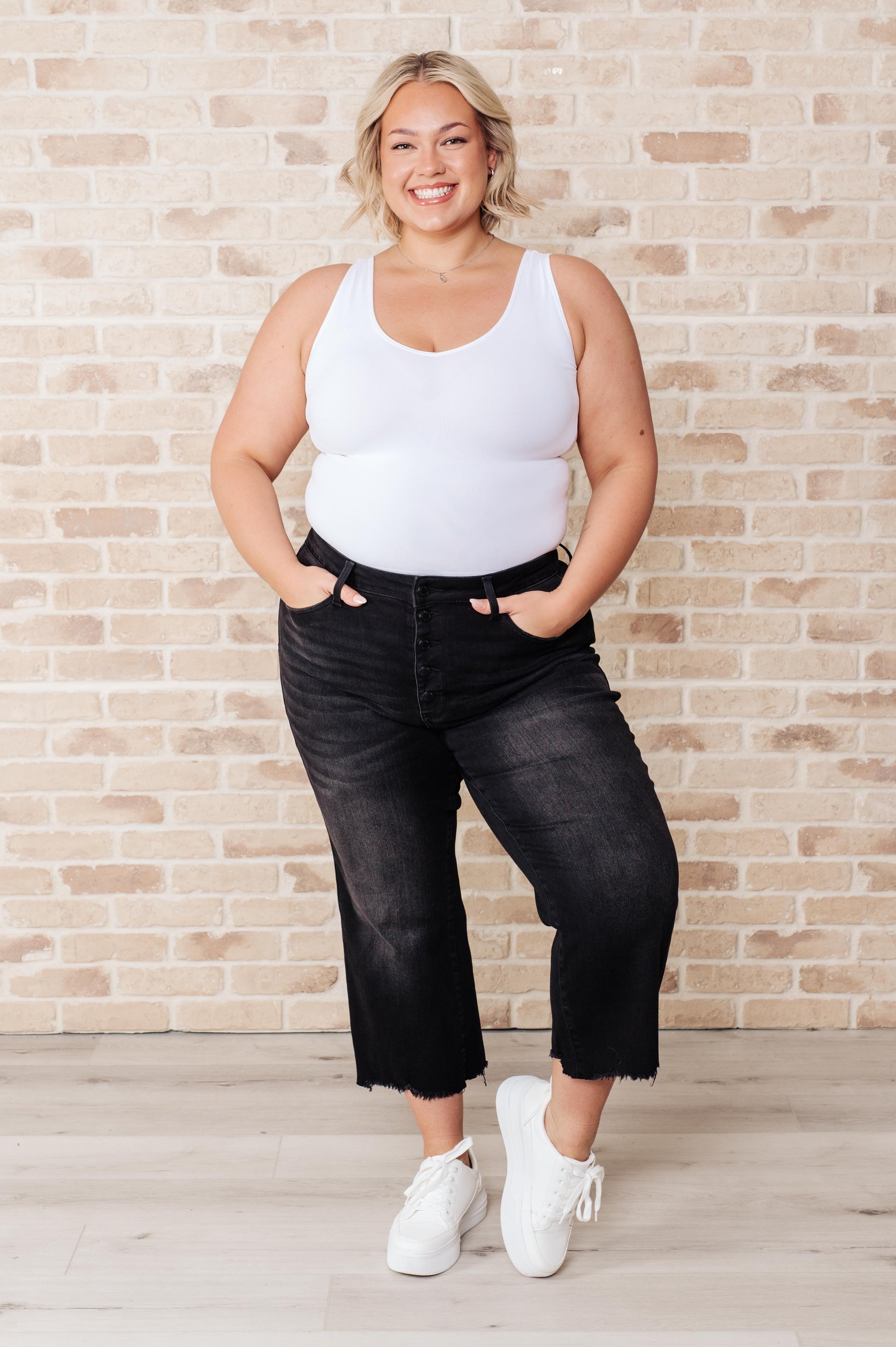 Get ready to rock stylishly with Ryan High Rise Jeans! These wide leg crop jeans feature a coordinating button fly and a washed out black garment dye for a cool, edgy look. With a high rise and raw hem, you'll stand out in the best way possible.  0-24W