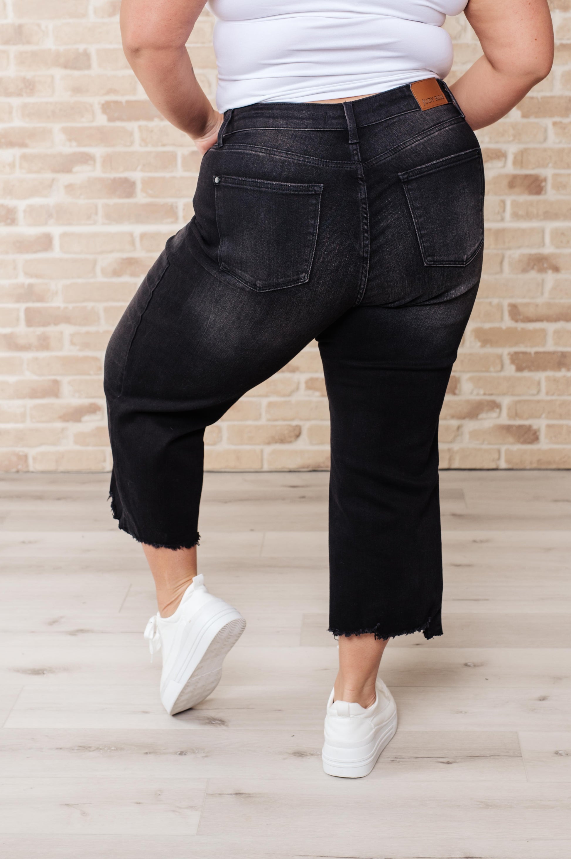 Get ready to rock stylishly with Ryan High Rise Jeans! These wide leg crop jeans feature a coordinating button fly and a washed out black garment dye for a cool, edgy look. With a high rise and raw hem, you'll stand out in the best way possible.  0-24W