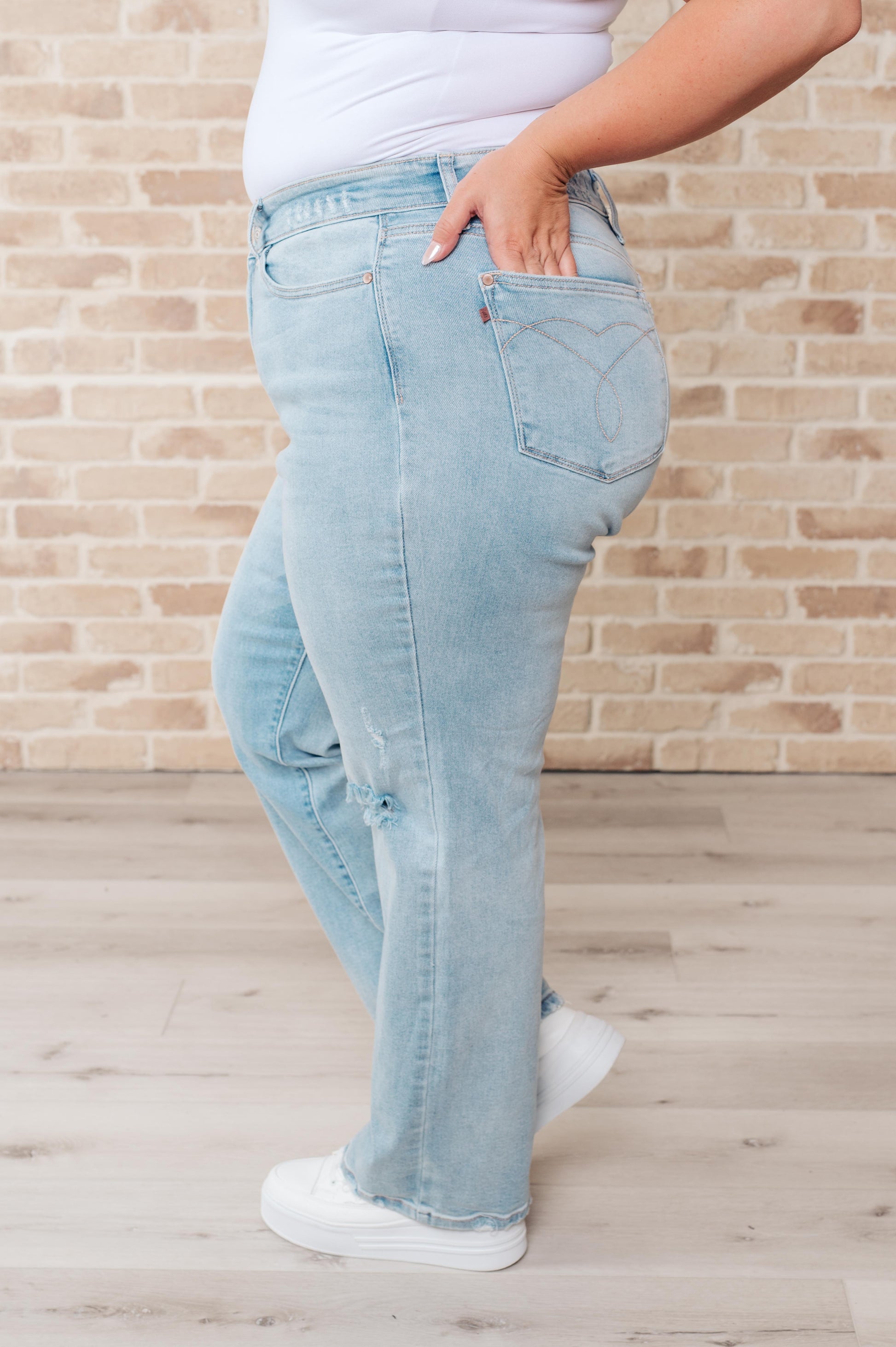 Rock the hottest trend with the Parker High Rise 90's Straight Jeans! Featuring a light wash and distressed front and back, these jeans offer a unique and stylish look. Their high rise and 90's straight silhouette provide a flattering fit for any body type. Upgrade your wardrobe with these must-have jeans! 0-24W