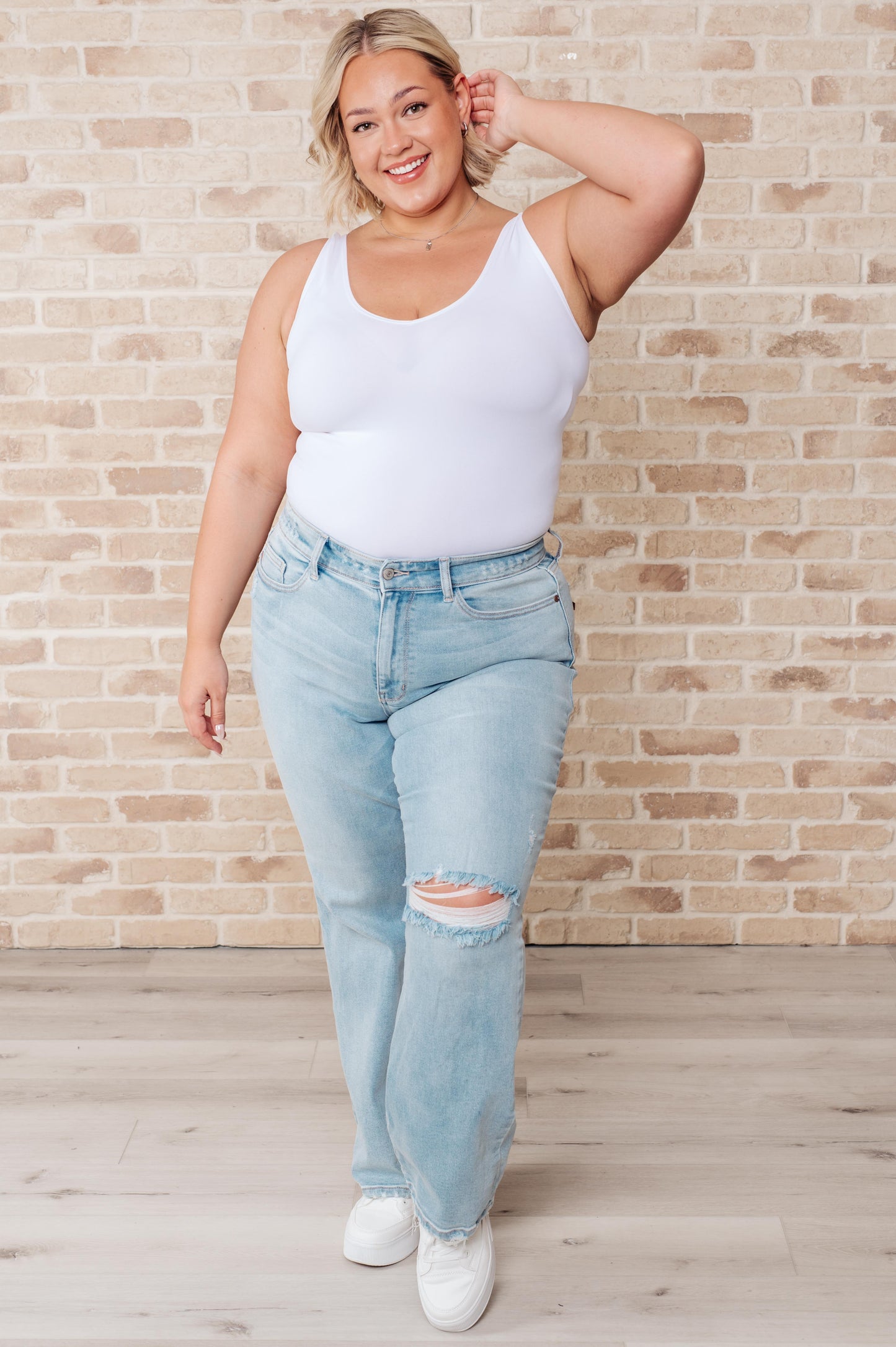 Rock the hottest trend with the Parker High Rise 90's Straight Jeans! Featuring a light wash and distressed front and back, these jeans offer a unique and stylish look. Their high rise and 90's straight silhouette provide a flattering fit for any body type. Upgrade your wardrobe with these must-have jeans! 0-24W