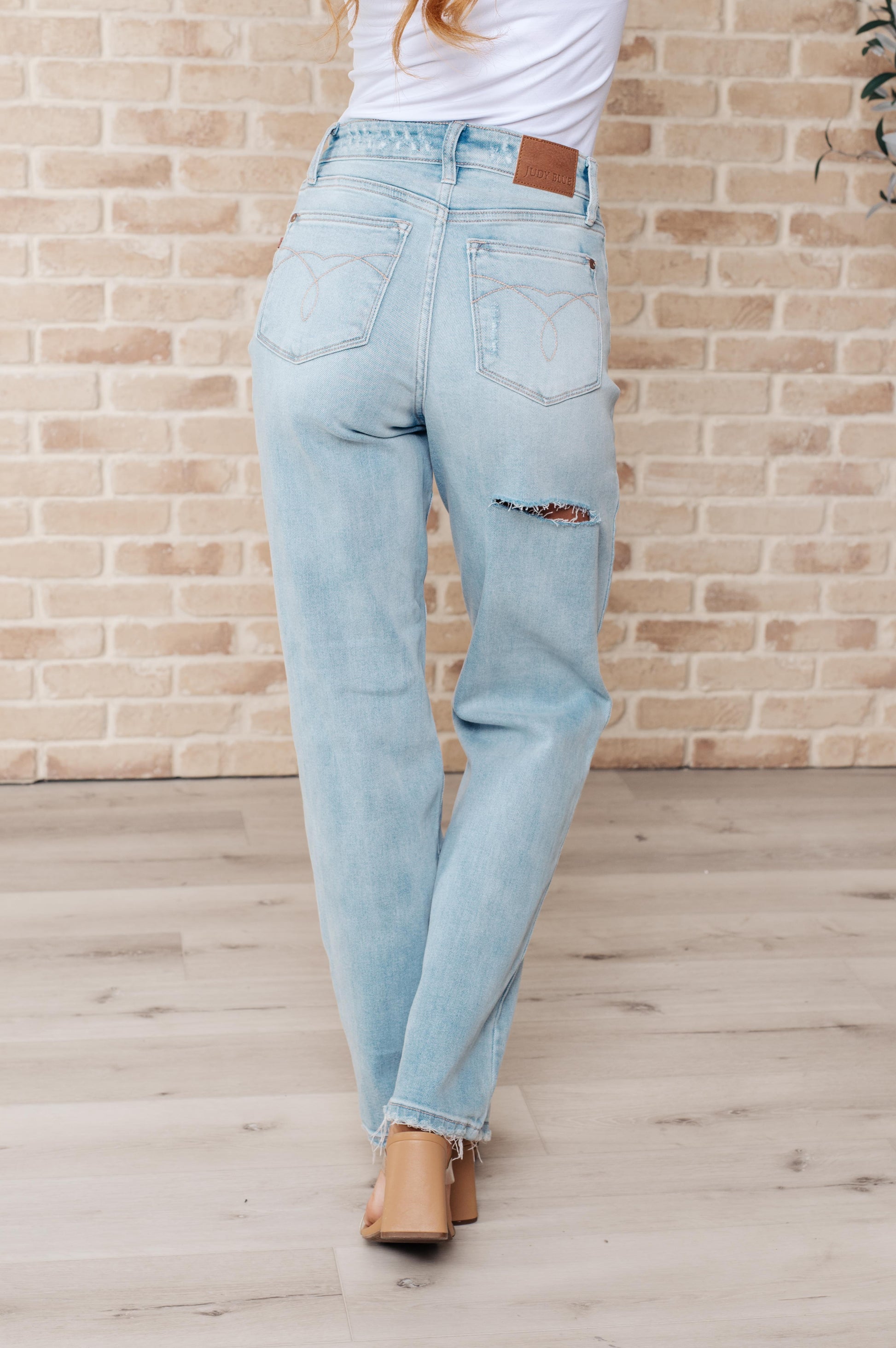 Rock the hottest trend with the Parker High Rise 90's Straight Jeans! Featuring a light wash and distressed front and back, these jeans offer a unique and stylish look. Their high rise and 90's straight silhouette provide a flattering fit for any body type. Upgrade your wardrobe with these must-have jeans! 0-24W