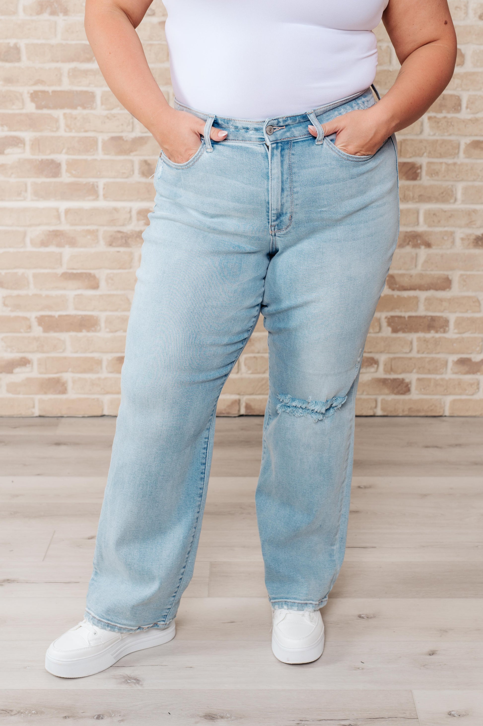 Rock the hottest trend with the Parker High Rise 90's Straight Jeans! Featuring a light wash and distressed front and back, these jeans offer a unique and stylish look. Their high rise and 90's straight silhouette provide a flattering fit for any body type. Upgrade your wardrobe with these must-have jeans! 0-24W