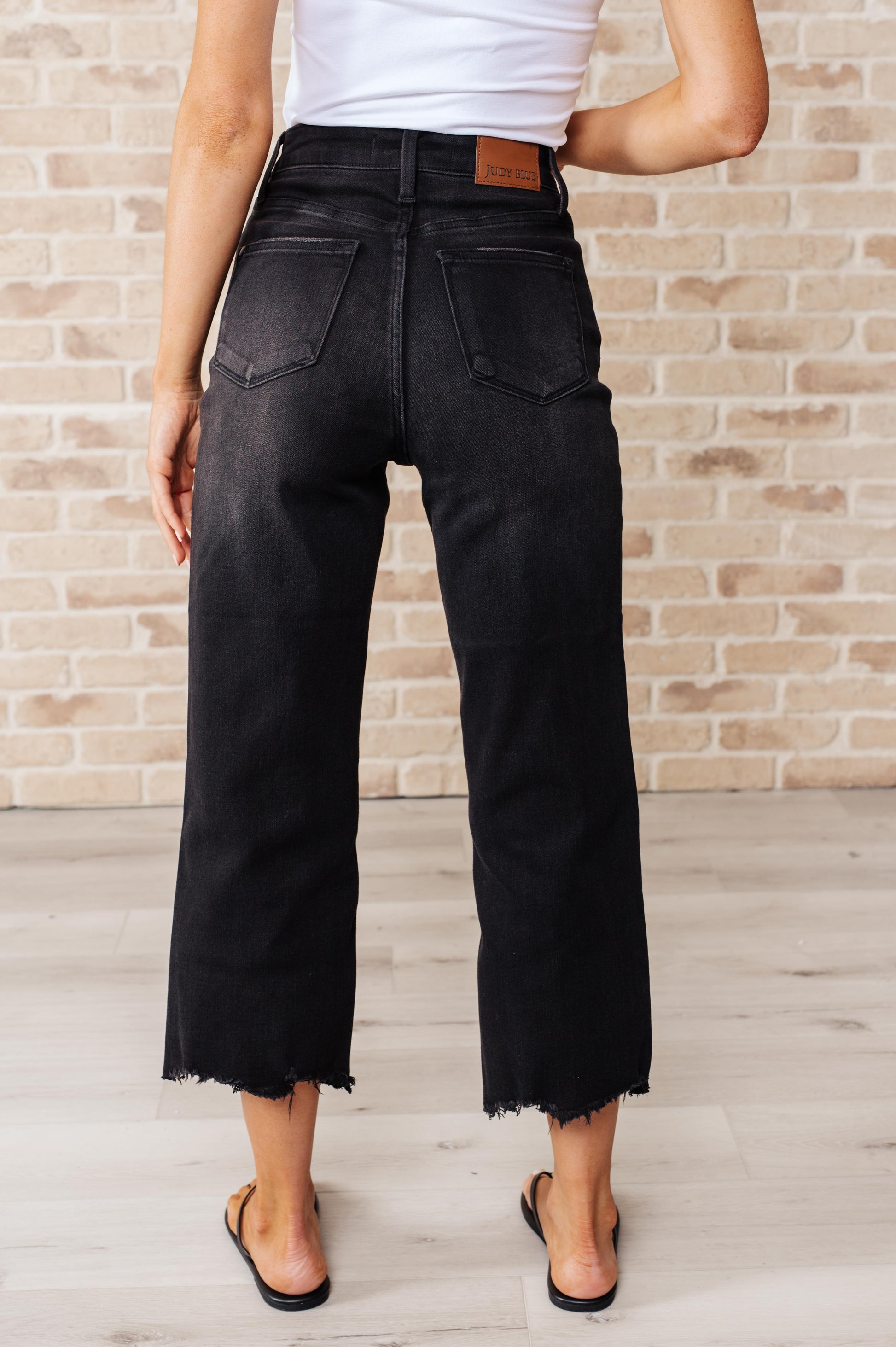 Get ready to rock stylishly with Ryan High Rise Jeans! These wide leg crop jeans feature a coordinating button fly and a washed out black garment dye for a cool, edgy look. With a high rise and raw hem, you'll stand out in the best way possible.  0-24W