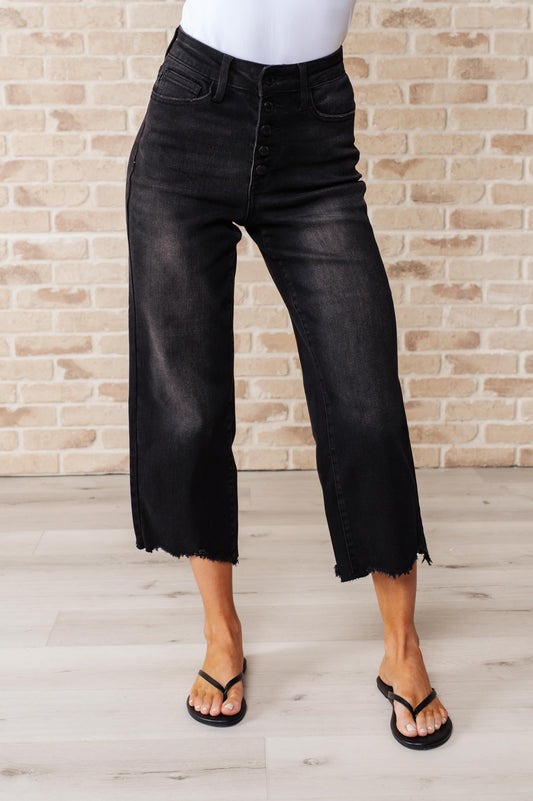 Get ready to rock stylishly with Ryan High Rise Jeans! These wide leg crop jeans feature a coordinating button fly and a washed out black garment dye for a cool, edgy look. With a high rise and raw hem, you'll stand out in the best way possible.  0-24W