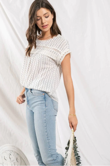 Feel flirty and fun in our Zig Zag Top! This cute top has an eye catching lace trim round neckline, extended shoulders, and dolman sleeves with lace trim. Plus, the front lace inset detail and back non-functional buttons will keep heads turning! Who says fashion can't be playful? Sashay into the room in this statement piece!