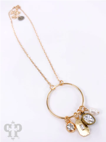 Pink Panache: Sandra Pink Panache necklace Color: Circle pendant with 8mm clear drop and charms on gold chain necklace Limited supply! Keywords: Necklace, Jewelry