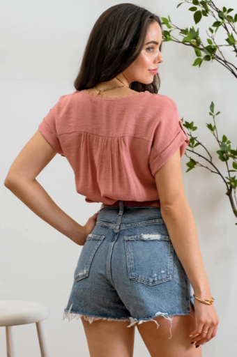 Add a touch of whimsy to your wardrobe with our "Paradise Dusty Apricot" lace top! Featuring round neck and classic lace trim, plus a button tab sleeve and short sleeve, you'll feel like you're in a floral-filled wonderland. (Oh yeah!) So, bring on the romance!