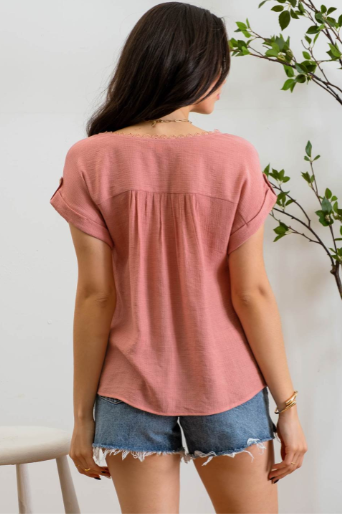 Add a touch of whimsy to your wardrobe with our "Paradise Dusty Apricot" lace top! Featuring round neck and classic lace trim, plus a button tab sleeve and short sleeve, you'll feel like you're in a floral-filled wonderland. (Oh yeah!) So, bring on the romance!