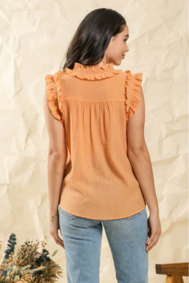 Make a splash this summer with this "Fun In The Sun Dusty Apricot" top! Indulge in the split neckline with self tie, and dance the day away with the ruffles and lace detail that flutter along the neck and arm openings. Time to unleash your carefree summer spirit!