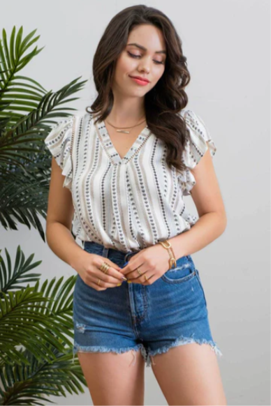 Be cool and breezy with this chambray-inspired Cindy Ivory & Blue Patterned Top! Its v-neckline and short ruffle sleeves with lace trim give it a sweet and sassy look. The back yoke and non-functional buttons round out the look, with a subtle hint of western-style flair. Yee-haw!!