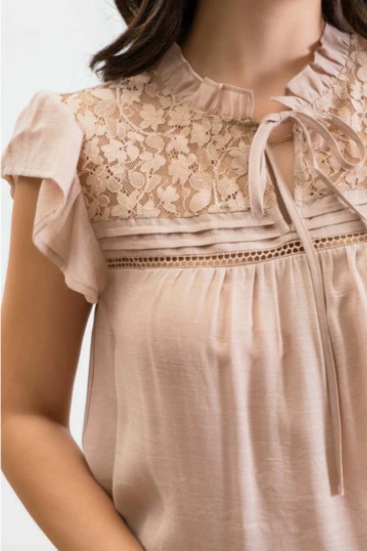 Freshen up your wardrobe with the "Faith Light Mocha" top! With split neckline, flutter sleeves, and lace detail, this top is perfect for any occasion. And tie it with a cute neck tie for an extra WOW factor. Be bold, be beautiful, and stay full of faith!