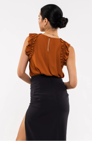 Be your sassiest self in this sleeveless top featuring a perfectly folded, eye-catching ruffle! This rust-hued classic features a woven fabric - so go ahead and look ultra-chic with minimal effort. A top that'll have you sayin' "ruffle-it-up!" Sizes small through large.