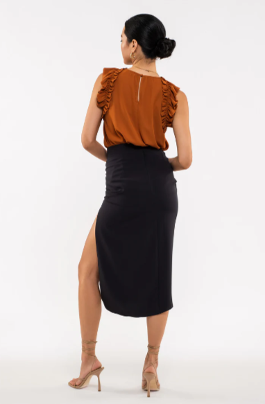 Be your sassiest self in this sleeveless top featuring a perfectly folded, eye-catching ruffle! This rust-hued classic features a woven fabric - so go ahead and look ultra-chic with minimal effort. A top that'll have you sayin' "ruffle-it-up!" Sizes small through large.