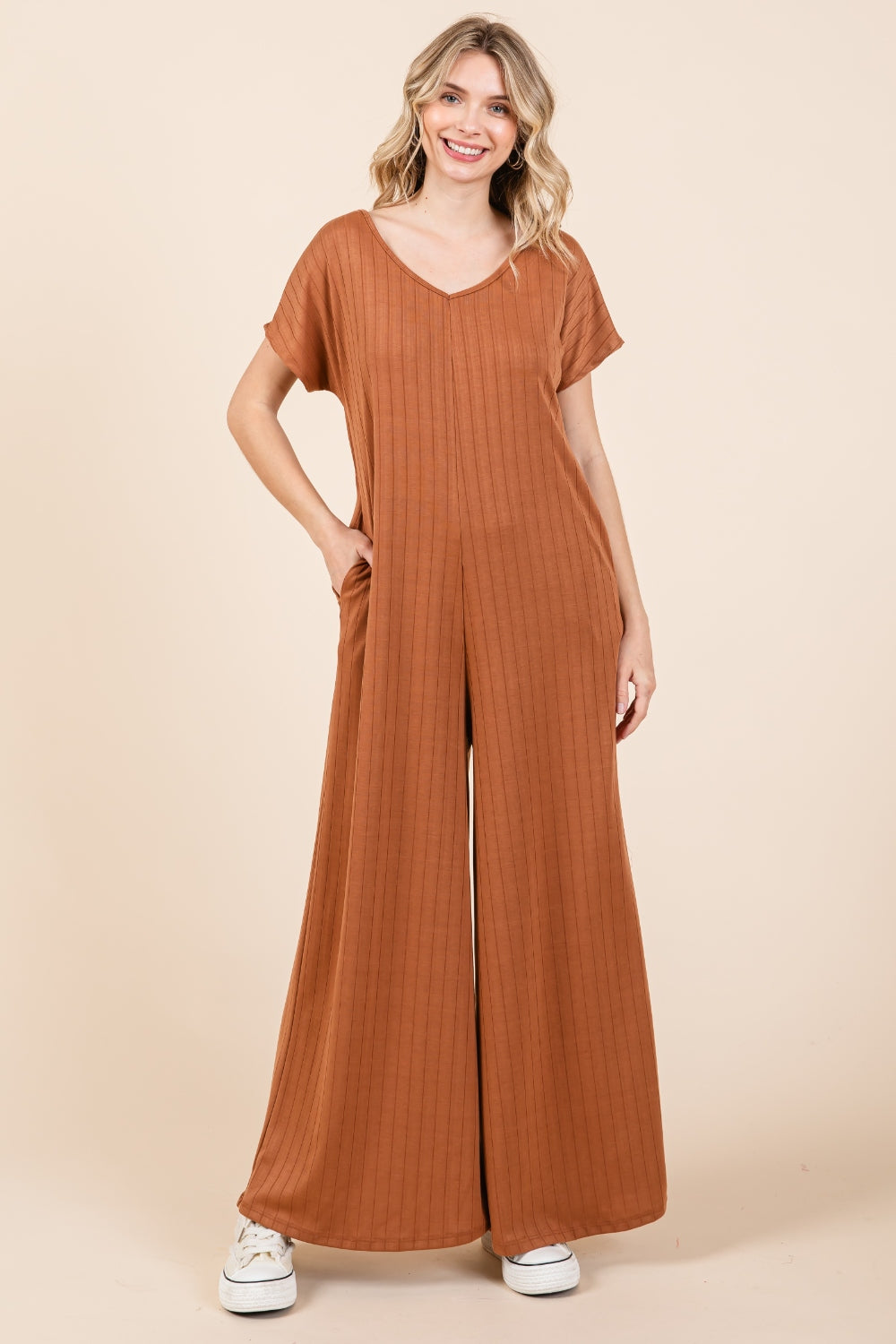 The Ribbed Short Sleeve Wide Leg Jumpsuit is a trendy and versatile fashion piece that offers both style and comfort. With a ribbed texture and wide-leg silhouette, this jumpsuit combines a chic look with a relaxed fit. The short sleeves add a casual touch, making it suitable for various occasions. S-XL