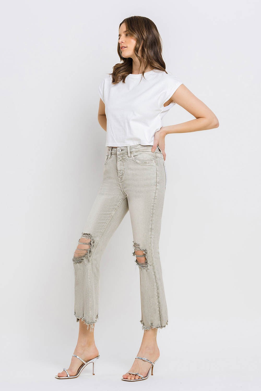 These distressed raw hem cropped flare jeans offer a perfect blend of edgy and retro style. The distressed detailing adds a touch of urban flair to the flared silhouette. The raw hem finishes off the look with a trendy, unfinished edge. Pair these jeans with a tucked-in graphic tee and platform sandals for a vintage-inspired outfit. 24-32
