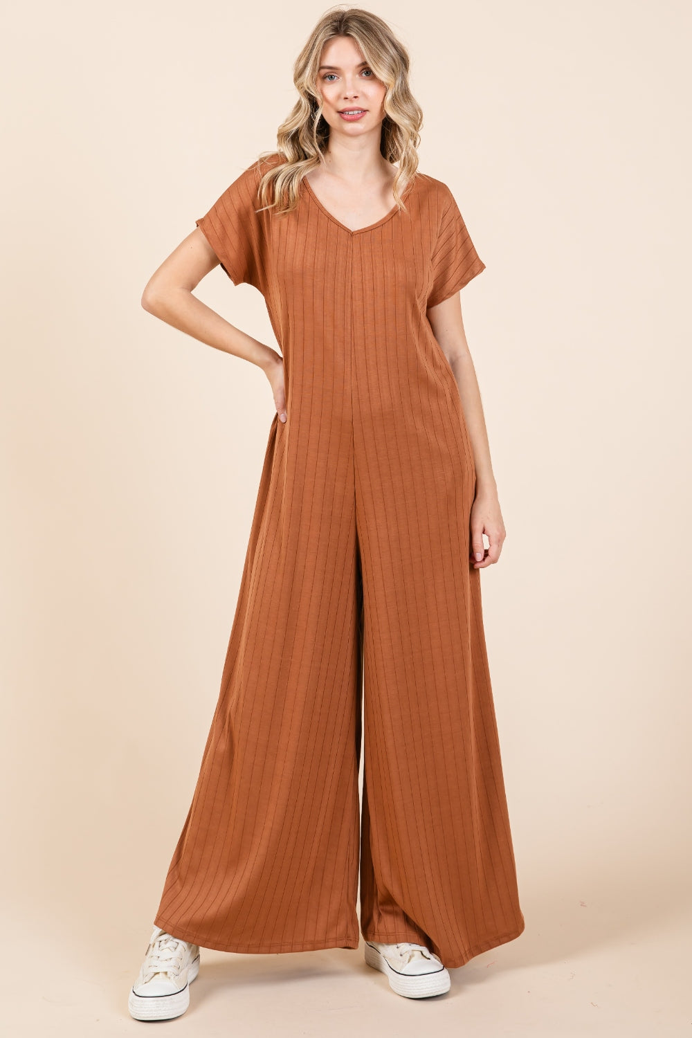 The Ribbed Short Sleeve Wide Leg Jumpsuit is a trendy and versatile fashion piece that offers both style and comfort. With a ribbed texture and wide-leg silhouette, this jumpsuit combines a chic look with a relaxed fit. The short sleeves add a casual touch, making it suitable for various occasions. S-XL