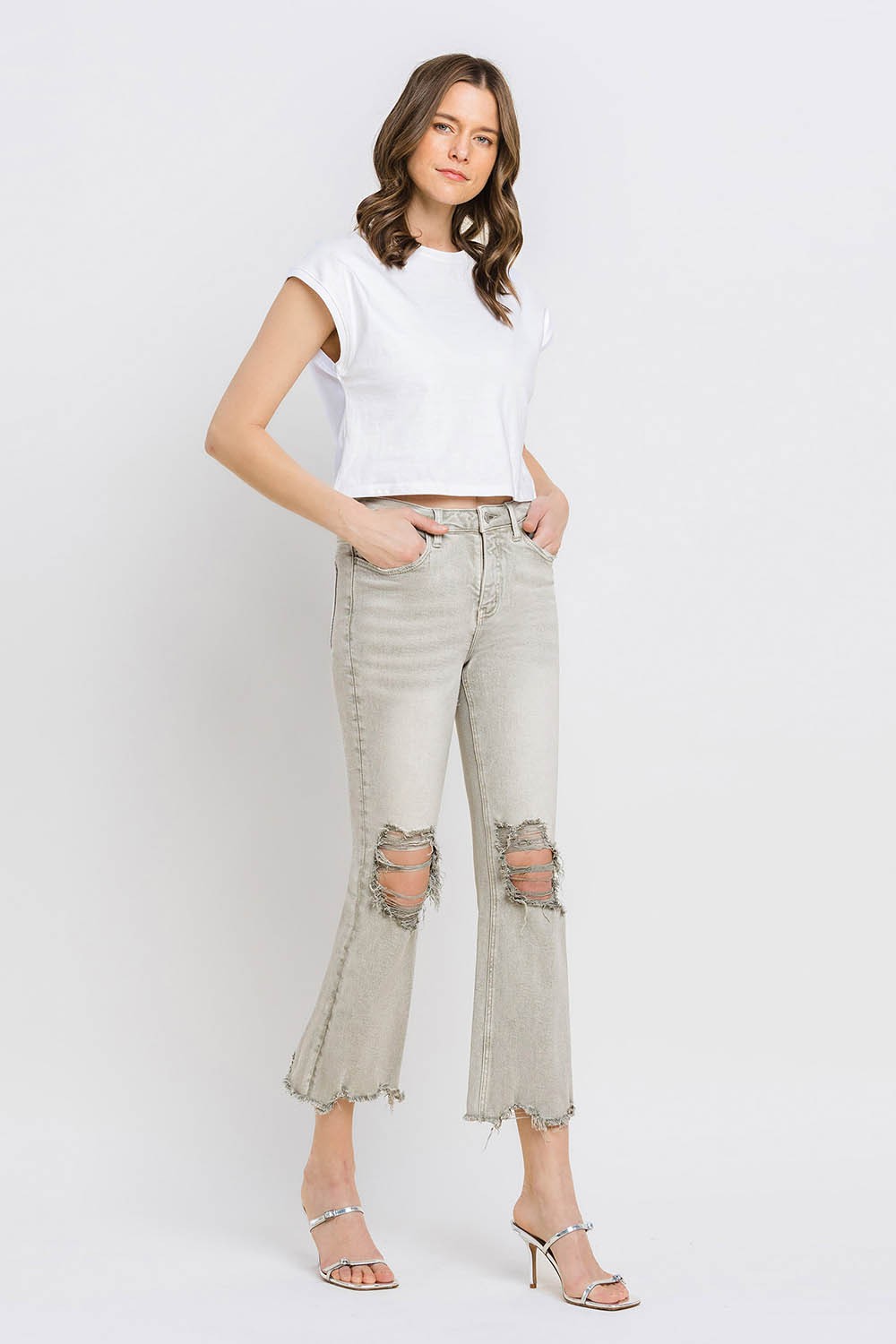 These distressed raw hem cropped flare jeans offer a perfect blend of edgy and retro style. The distressed detailing adds a touch of urban flair to the flared silhouette. The raw hem finishes off the look with a trendy, unfinished edge. Pair these jeans with a tucked-in graphic tee and platform sandals for a vintage-inspired outfit.  24-32