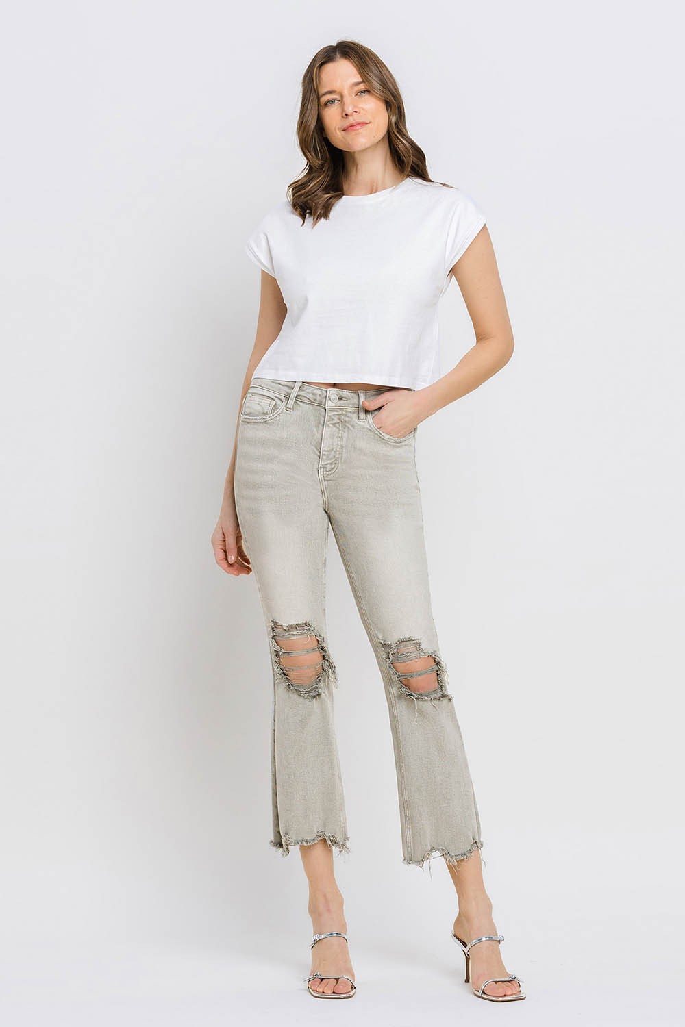 These distressed raw hem cropped flare jeans offer a perfect blend of edgy and retro style. The distressed detailing adds a touch of urban flair to the flared silhouette. The raw hem finishes off the look with a trendy, unfinished edge. Pair these jeans with a tucked-in graphic tee and platform sandals for a vintage-inspired outfit.  24-32