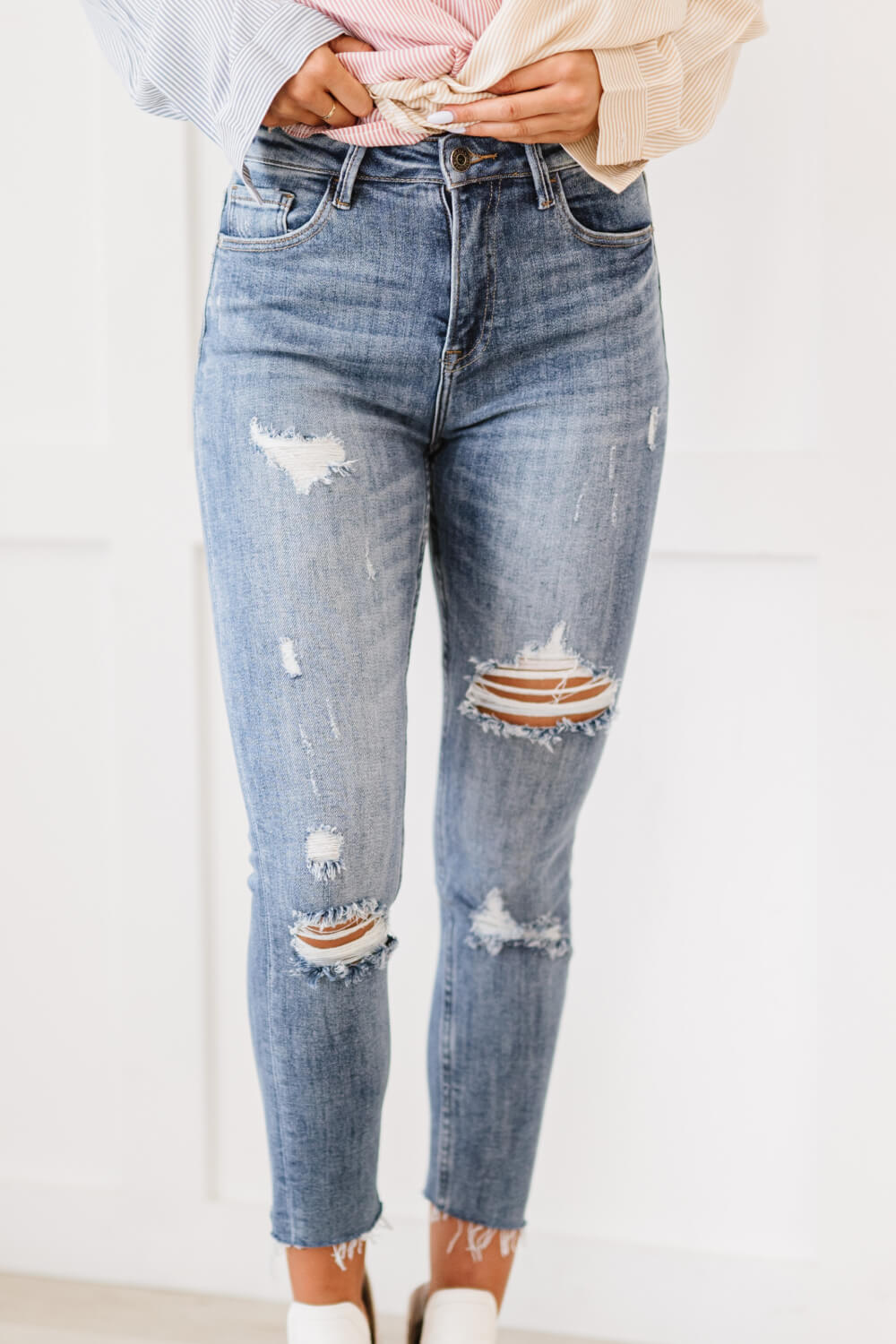 "Melissa Denim" are distressed skinny jeans that are the perfect addition to your wardrobe. They are comfortable and stylish, and can be dressed up or down. The distressed look is perfect for a casual day out, and the skinny fit will show off your curves. These are a medium wash. Sizes 3-11