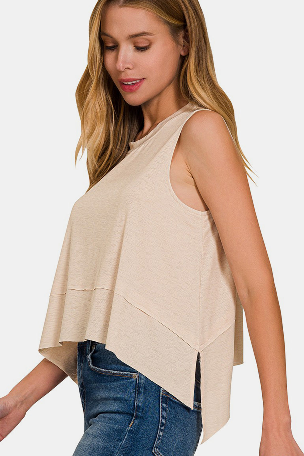 Exposed Seam Slit Round Neck Tank is a modern and stylish wardrobe essential. The exposed seam detailing adds a trendy touch to this classic tank top, giving it an edgy and contemporary look. With a round neck and slit detailing, this tank is versatile and can be dressed up or down for any occasion.  S-L