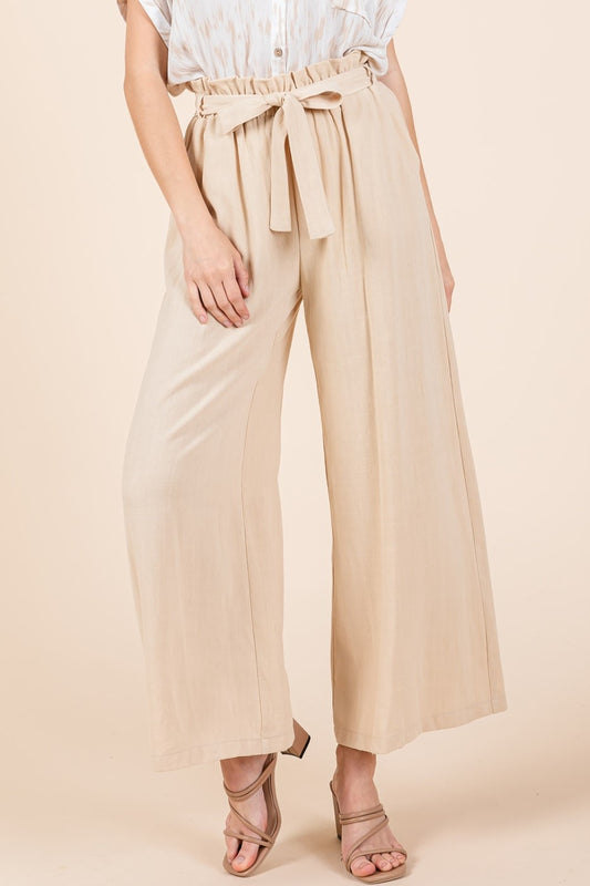 High Waist Tie Front Wide Leg Pants are a stylish and flattering bottom option that features a high waist and wide legs with a tie-front detail. The high waist design accentuates the waistline and creates a long and lean silhouette. The wide legs offer a flowy and relaxed fit, providing comfort and a chic look. S-L
