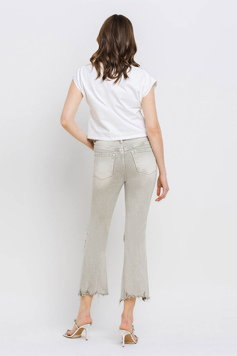 These distressed raw hem cropped flare jeans offer a perfect blend of edgy and retro style. The distressed detailing adds a touch of urban flair to the flared silhouette. The raw hem finishes off the look with a trendy, unfinished edge. Pair these jeans with a tucked-in graphic tee and platform sandals for a vintage-inspired outfit. 24-32