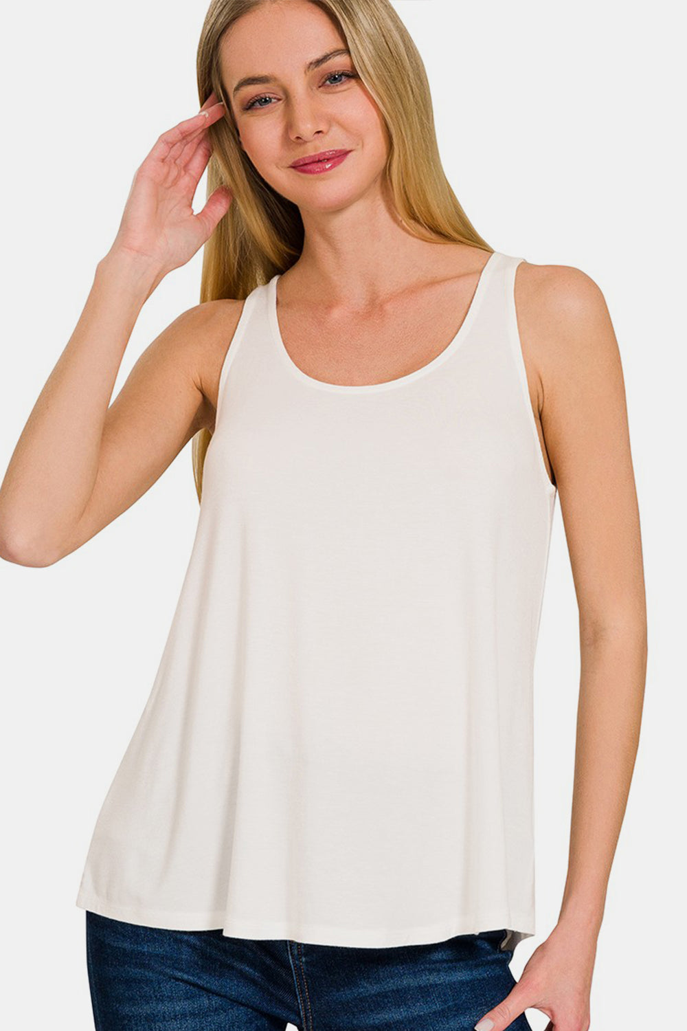 The Round Neck Flowy Hem Tank is a stylish and versatile clothing piece that features a flattering flowy hem design. It is perfect for casual outings or even dressed up with accessories for a more sophisticated look. The round neck adds a classic touch to the tank top, making it easy to pair with different bottoms. S-XL