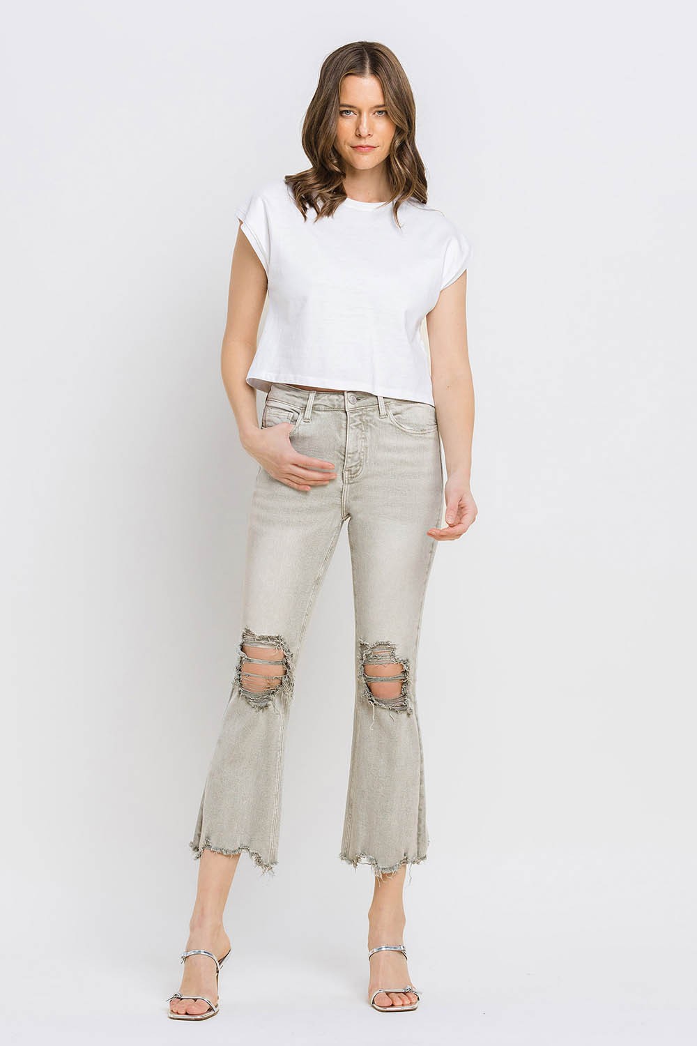 These distressed raw hem cropped flare jeans offer a perfect blend of edgy and retro style. The distressed detailing adds a touch of urban flair to the flared silhouette. The raw hem finishes off the look with a trendy, unfinished edge. Pair these jeans with a tucked-in graphic tee and platform sandals for a vintage-inspired outfit.  24-32