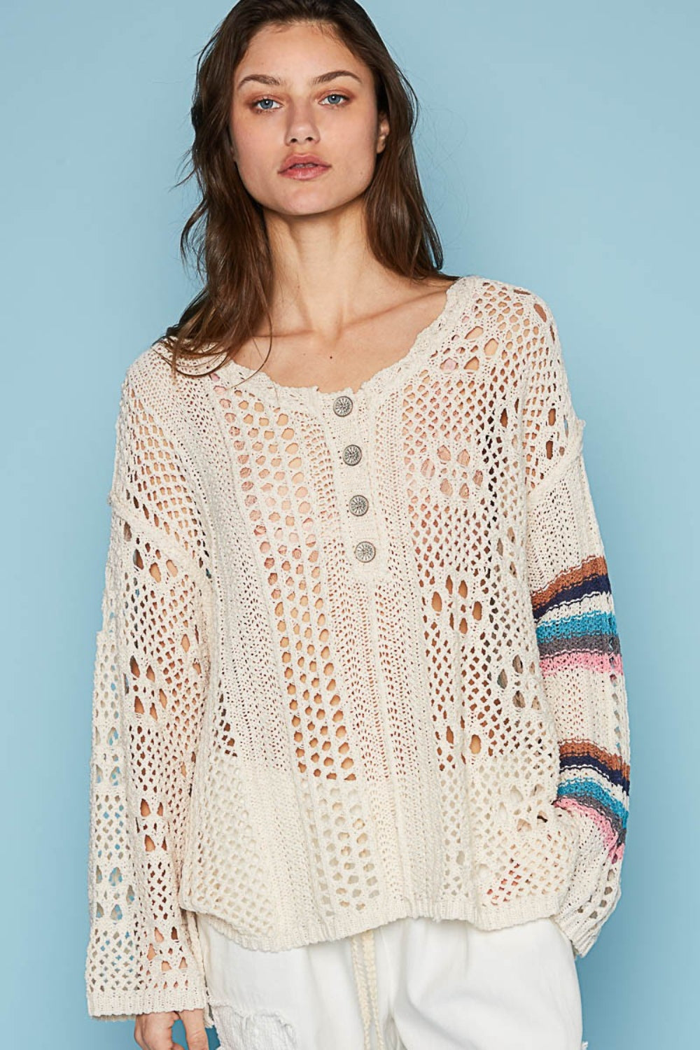 The round neck top with placket, straight sleeves, and a relaxed fit in acrylic sweater material is a cozy and stylish choice for cooler weather. The outseam edge detail and pointed solid pattern add a modern twist to the design, creating a chic and sophisticated look.