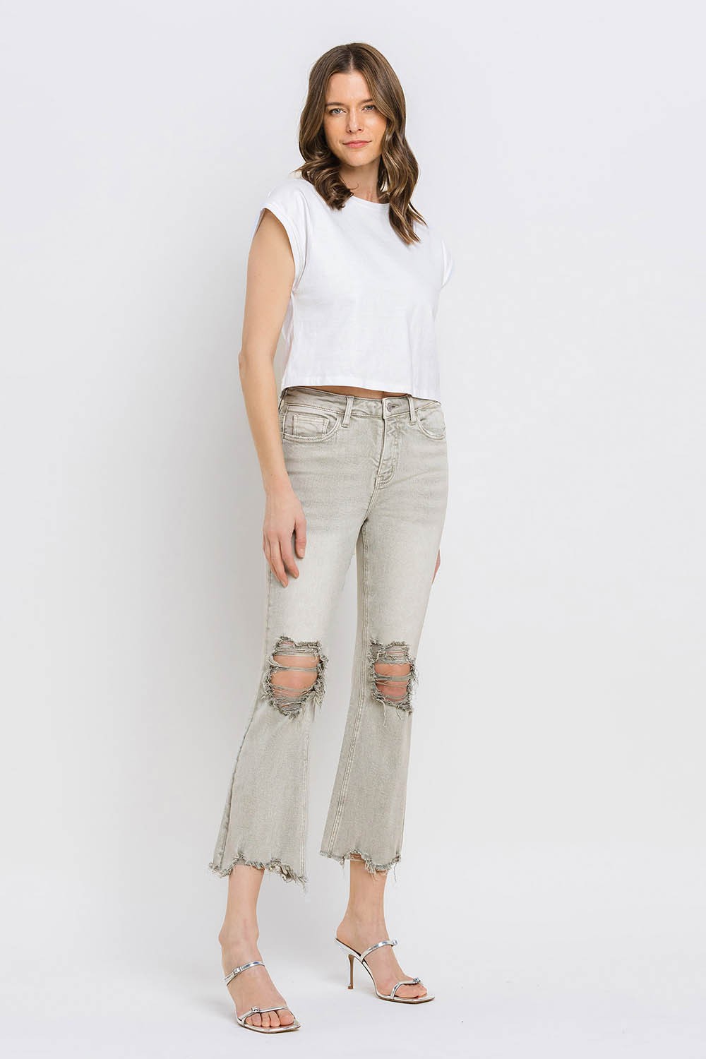 These distressed raw hem cropped flare jeans offer a perfect blend of edgy and retro style. The distressed detailing adds a touch of urban flair to the flared silhouette. The raw hem finishes off the look with a trendy, unfinished edge. Pair these jeans with a tucked-in graphic tee and platform sandals for a vintage-inspired outfit. 24-32