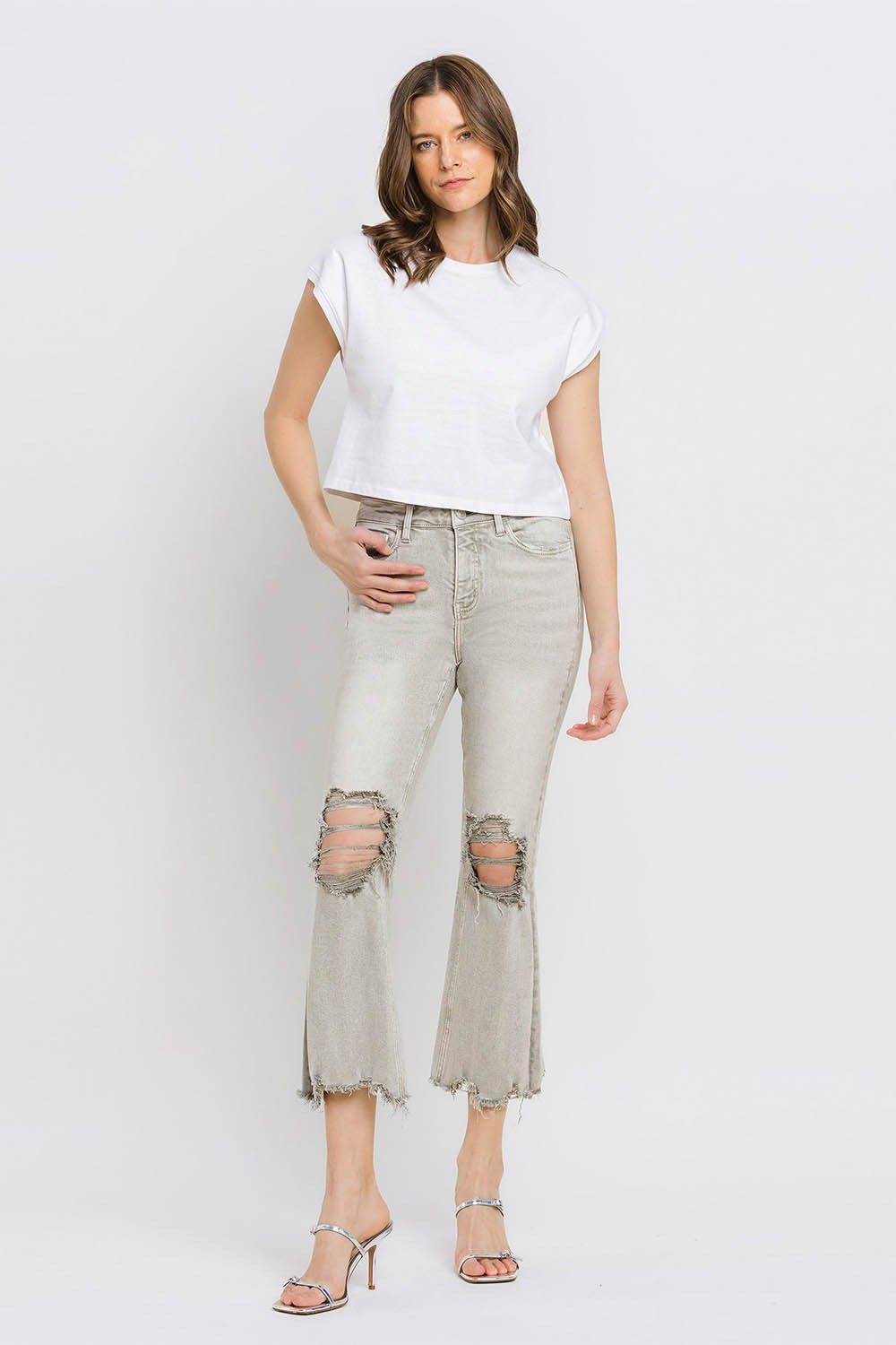 These distressed raw hem cropped flare jeans offer a perfect blend of edgy and retro style. The distressed detailing adds a touch of urban flair to the flared silhouette. The raw hem finishes off the look with a trendy, unfinished edge. Pair these jeans with a tucked-in graphic tee and platform sandals for a vintage-inspired outfit.  24-32