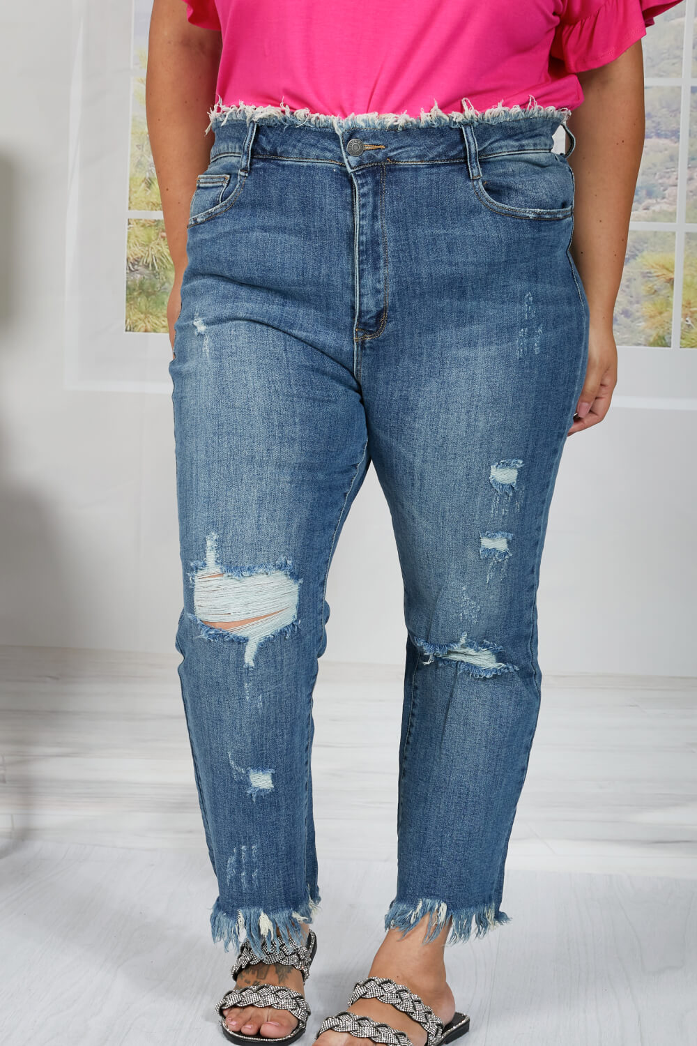 These straight leg jeans really amplify the "undone" look that you're trying to achieve. Not only do these jeans have distressing details throughout the body of the jeans, and at the hem, but also at the waist! To emphasize that unique feature, wear these jeans with a crop top. These are a medium wash. Sizes 5-11.