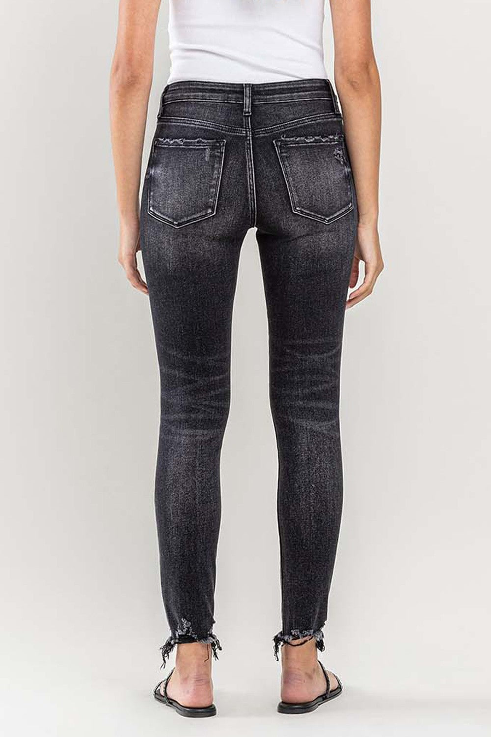 These raw hem cropped skinny jeans are a must-have for any fashion-forward individual. The raw hem adds a touch of edge to the classic skinny jeans silhouette. The cropped length is perfect for showcasing your favorite footwear. 24-32