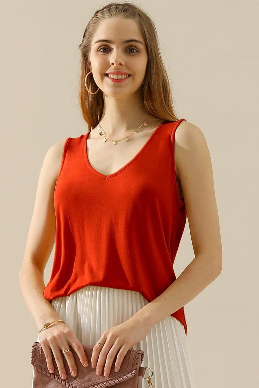 The V-Neck Curved Hem Tank is a stylish and versatile piece. With its flattering neckline and curved hem, it adds a touch of femininity to any outfit. The tank's relaxed fit provides comfort without sacrificing style. S - 3X